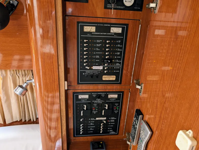 Slide: The Image of Control panel inside a 2005 Regal 3560 boat, featuring switches and gauges. - 25