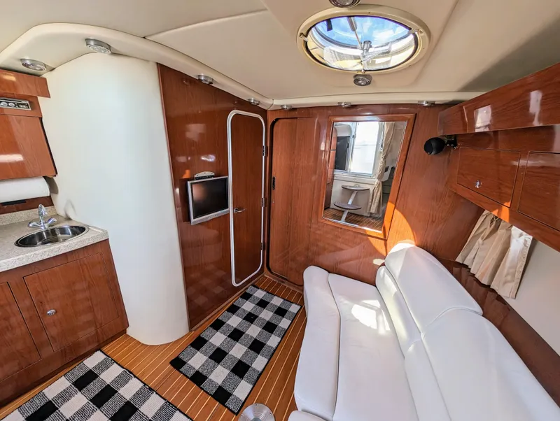 Slide: The Image of Luxurious interior of a 2005 Regal 3560 yacht with wood finish and modern amenities. - 26