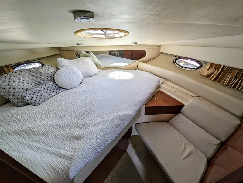 Slide: The Image of Luxurious cabin interior of a 2005 Regal 3560 yacht with cozy bedding and seating. - 27
