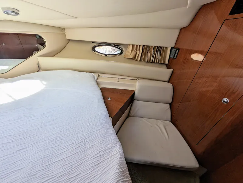 Slide: The Image of Interior cabin of a 2005 Regal 3560 yacht with bed and wooden paneling. - 29