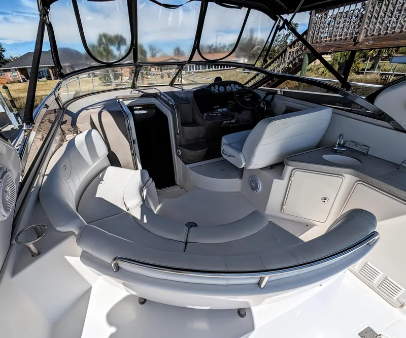 Slide: The Image of 2005 Regal 3560 yacht interior with seating, helm, and sink. - 3