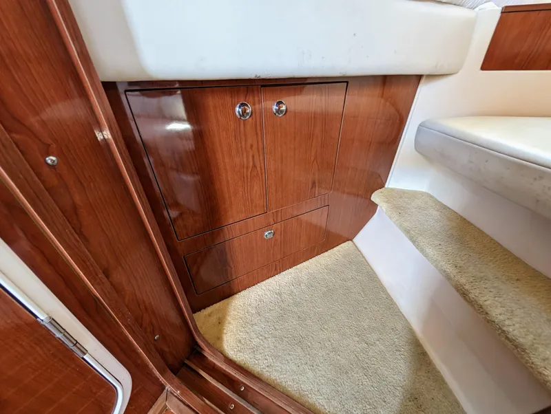 Slide: The Image of Interior of 2005 Regal 3560 yacht with wooden cabinetry and carpeted stairs. - 30