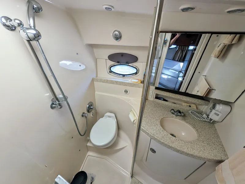 Slide: The Image of 2005 Regal 3560 yacht bathroom with shower, toilet, sink, and mirror. - 31
