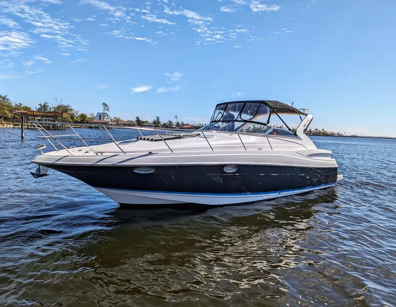 Slide: The Image of 2005 Regal 3560 yacht on calm water under a clear blue sky. - 38