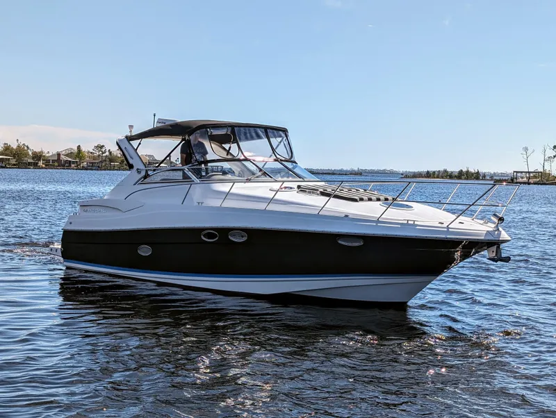 Slide: The Image of 2005 Regal 3560 yacht cruising on a sunny day in calm waters. - 39