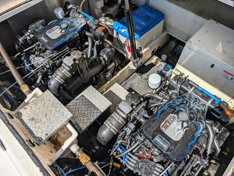 Slide: The Image of Engine compartment of a 2005 Regal 3560 boat, featuring dual engines and mechanical components. - 42