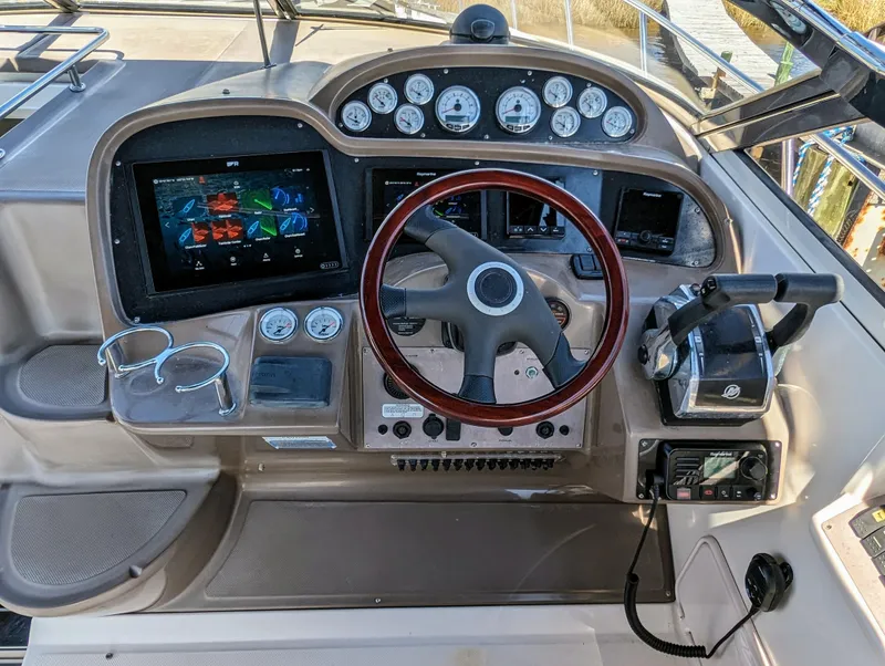 Slide: The Image of Control panel of a 2005 Regal 3560 boat with steering wheel and navigation instruments. - 8