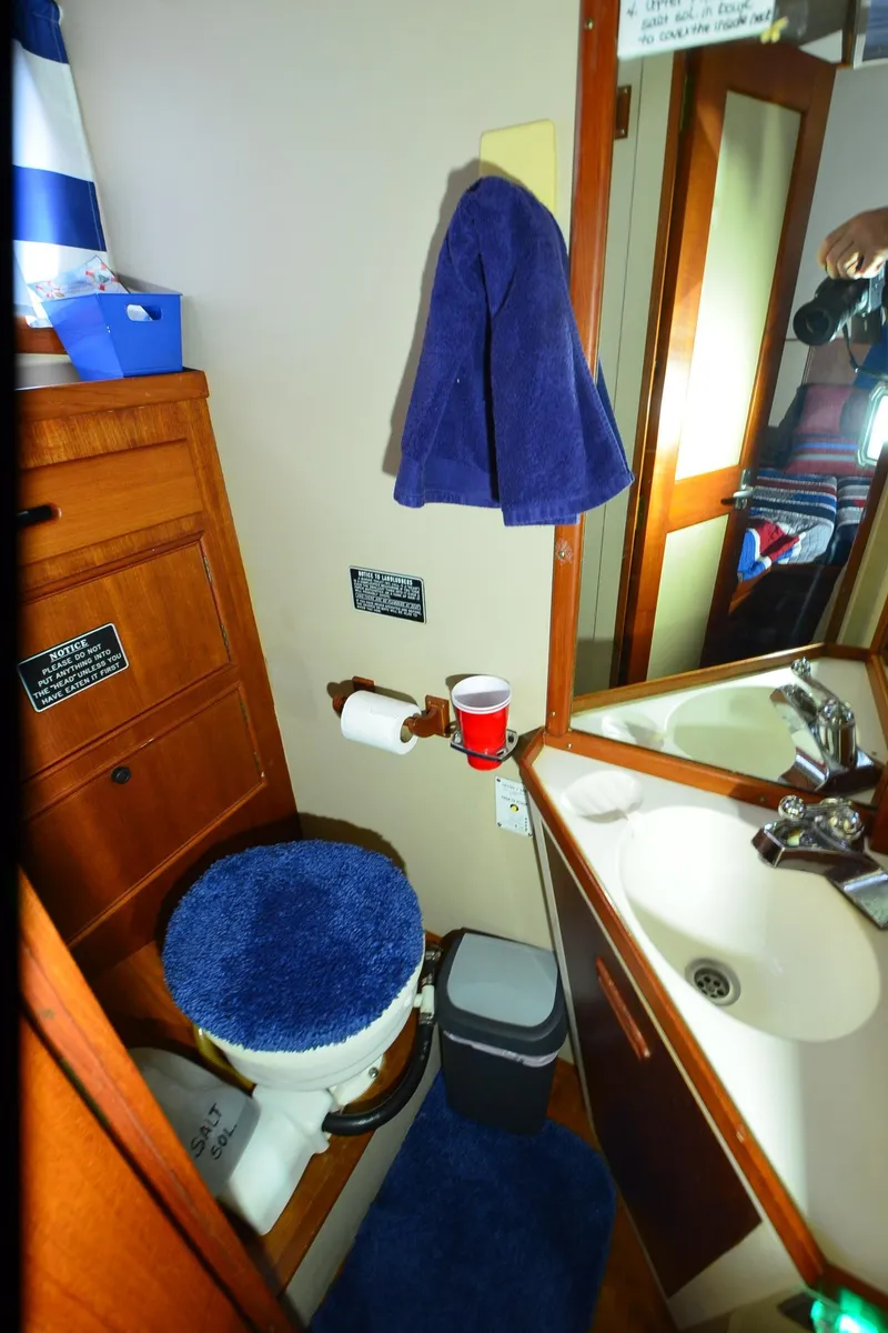 Slide: The Image of 1978 Grand Banks 36 Classic bathroom with sink, toilet, and wooden cabinetry. - 11