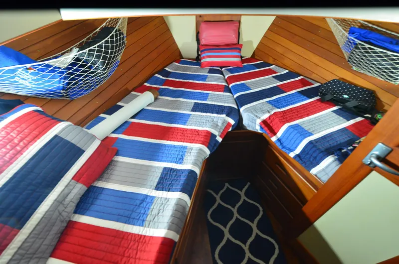Slide: The Image of Cabin interior of 1978 Grand Banks 36 Classic with colorful striped bedding. - 12