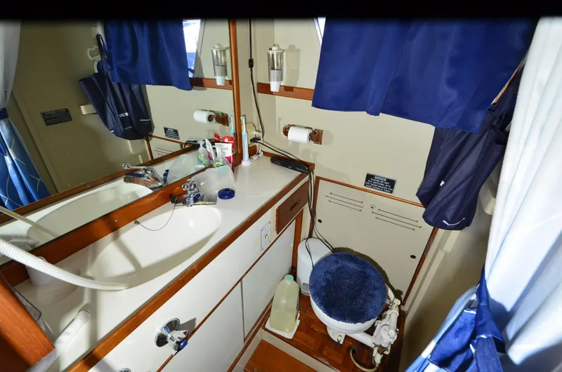 Slide: The Image of 1978 Grand Banks 36 Classic yacht bathroom with sink, mirror, and toilet. - 14