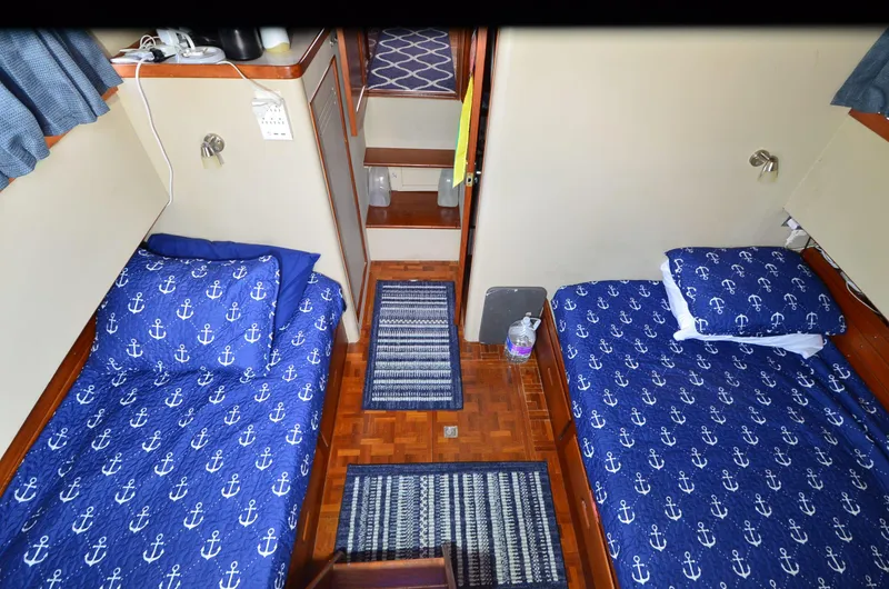 Slide: The Image of Cabin interior of 1978 Grand Banks 36 Classic with anchor-themed bedding. - 15