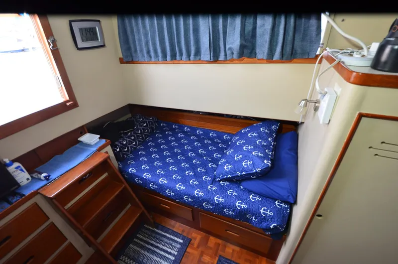 Slide: The Image of Cozy cabin interior of 1978 Grand Banks 36 Classic with nautical-themed bedding. - 17
