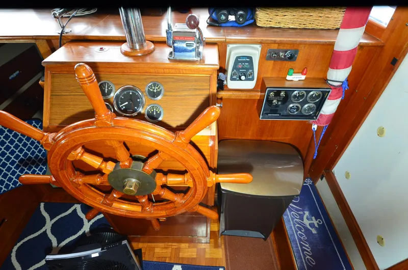Slide: The Image of 1978 Grand Banks 36 Classic helm with wooden wheel and nautical instruments. - 25
