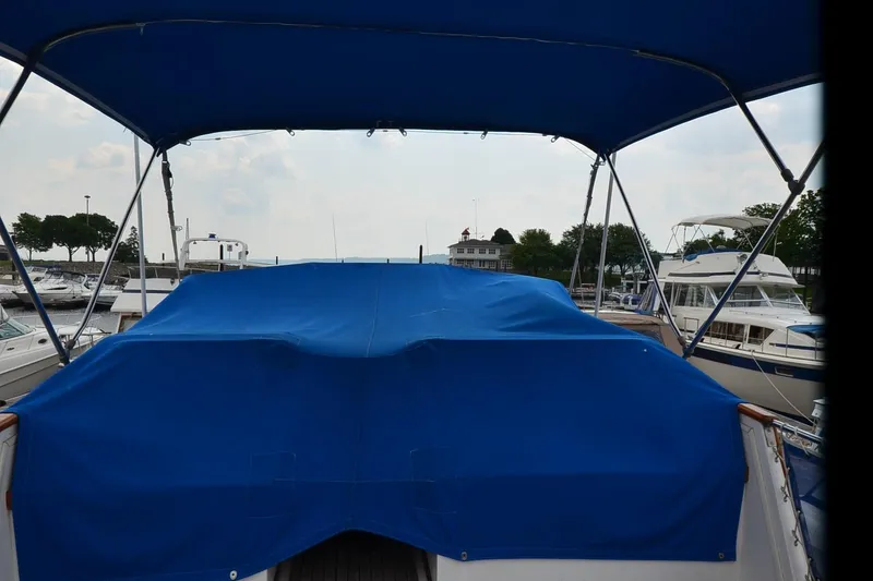 Slide: The Image of 1978 Grand Banks 36 Classic boat with blue canopy in marina setting. - 31