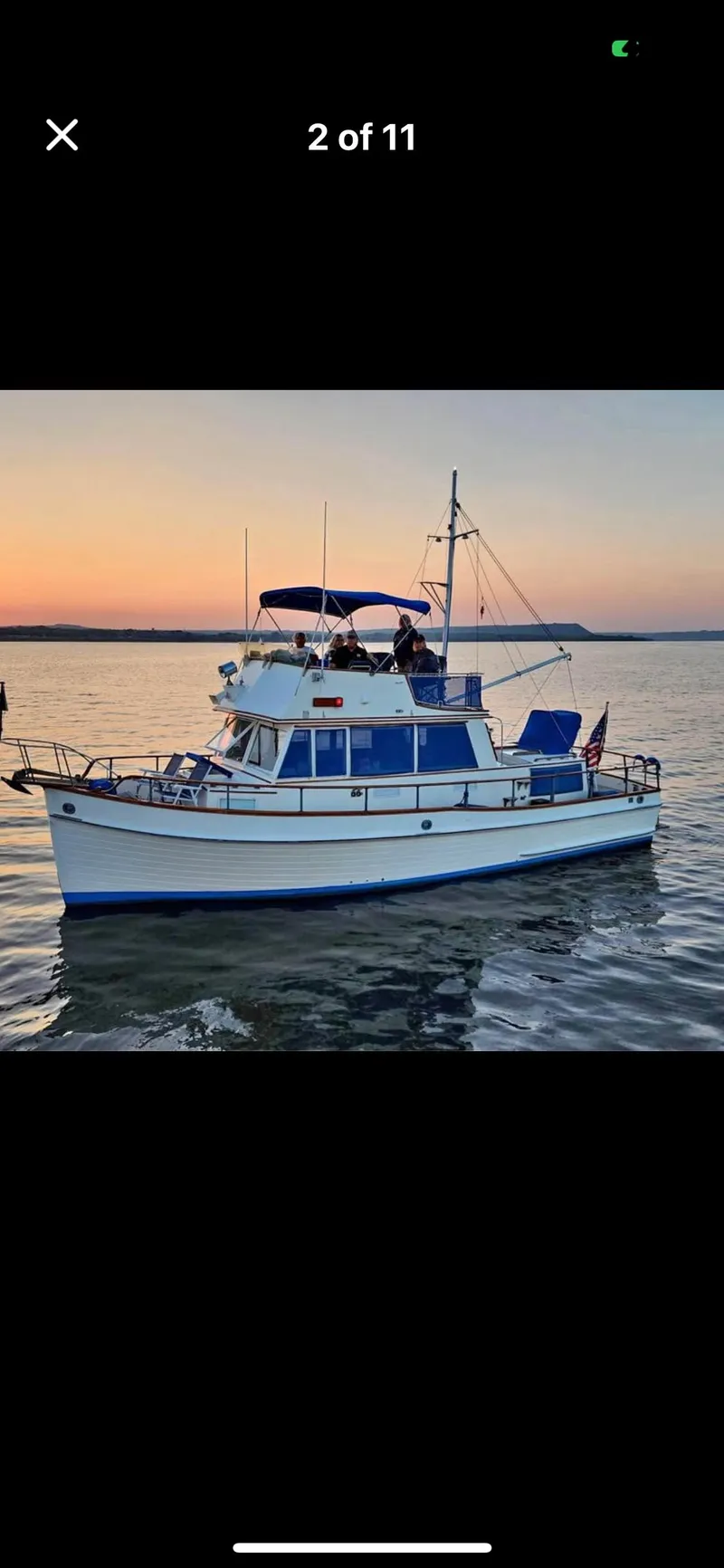 Slide: The Image of 1978 Grand Banks 36 Classic yacht on calm water at sunset. - 36