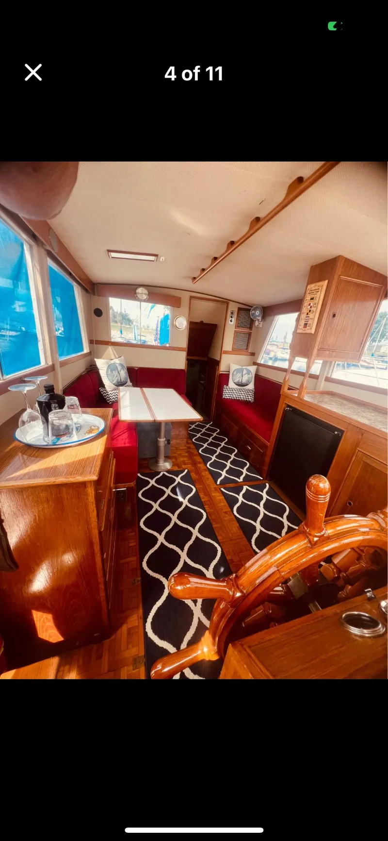 Slide: The Image of Interior of 1978 Grand Banks 36 Classic yacht with wooden helm and red seating. - 38