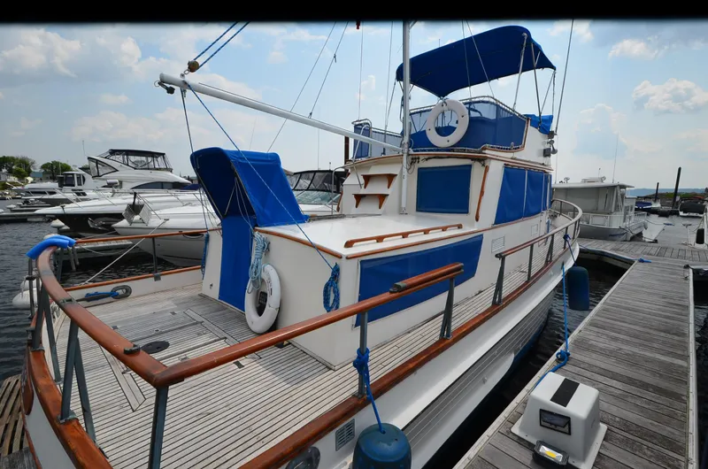 Slide: The Image of 1978 Grand Banks 36 Classic yacht docked at marina, featuring blue and white design. - 4
