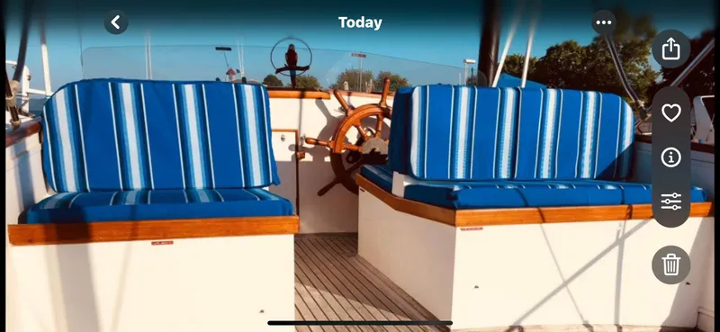Slide: The Image of 1978 Grand Banks 36 Classic boat interior with blue striped seating and wooden accents. - 40