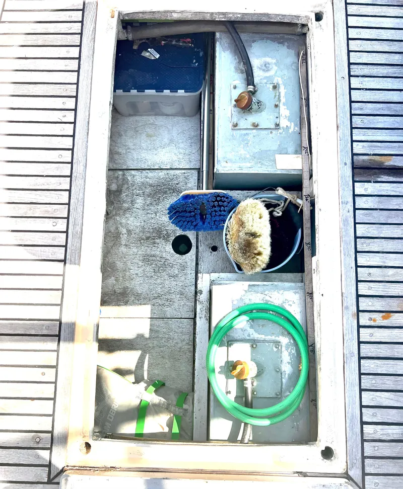 Slide: The Image of Open storage compartment on 1978 Grand Banks 36 Classic boat deck with cleaning supplies. - 43