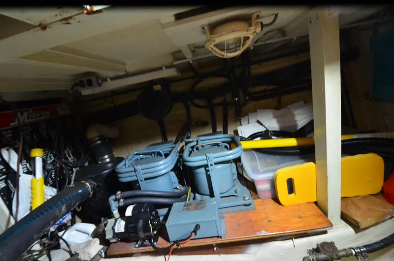 Slide: The Image of Engine room of a 1978 Grand Banks 36 Classic boat, showcasing mechanical components and storage. - 44