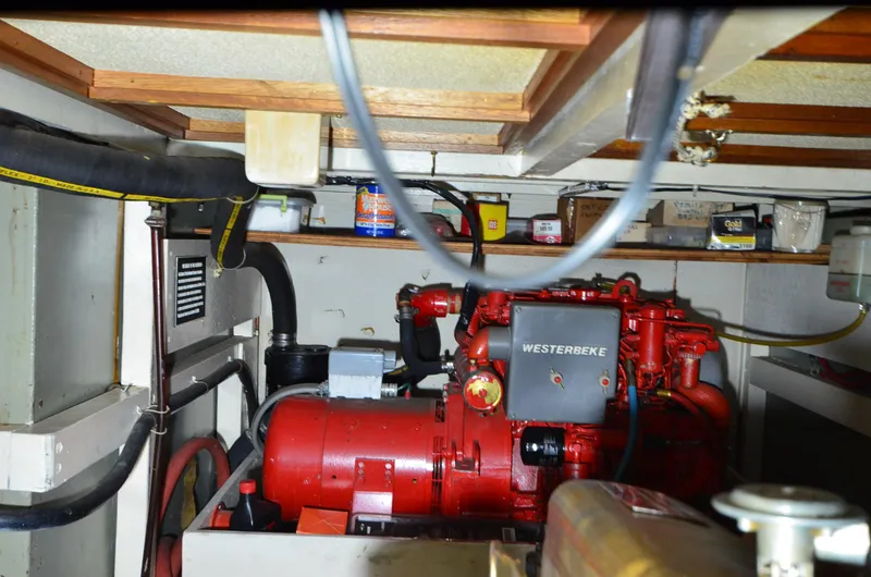 Slide: The Image of Engine room of a 1978 Grand Banks 36 Classic with a red Westerbeke engine. - 45