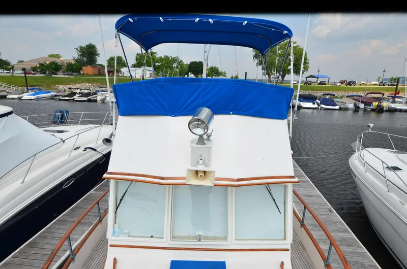 Slide: The Image of 1978 Grand Banks 36 Classic yacht docked at marina with blue canopy. - 7