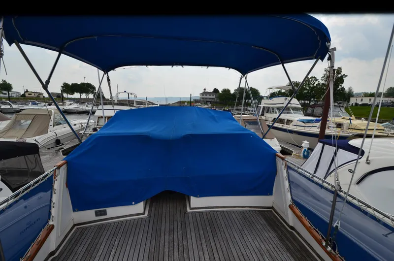 Slide: The Image of 1978 Grand Banks 36 Classic yacht with blue canopy at marina. - 8