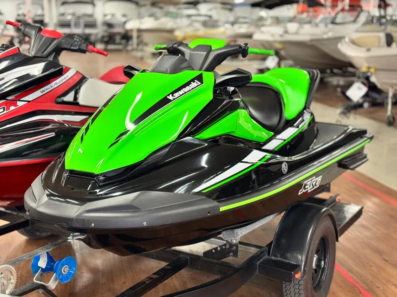 The Image of 2023 Kawasaki Jetski STX 160X in vibrant green and black on display in showroom. - 0