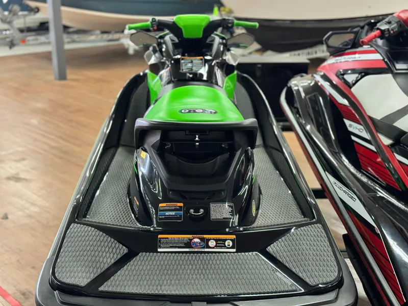 Slide: The Image of 2023 Kawasaki Jetski STX 160X in showroom, featuring sleek green and black design. - 3
