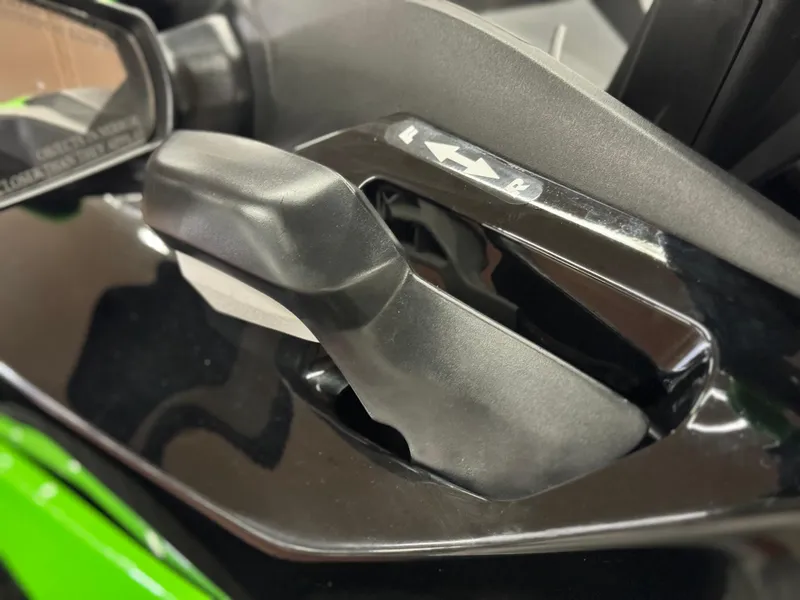 Slide: The Image of Close-up of 2023 Kawasaki Jetski STX 160X handlebar controls, featuring sleek black design. - 8