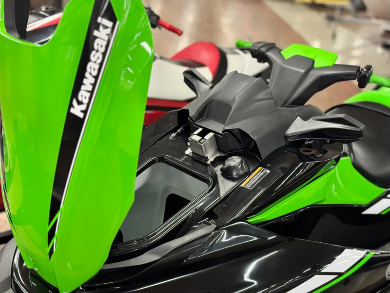 Slide: The Image of 2023 Kawasaki Jetski STX 160X in green and black, showcasing handlebars and storage compartment. - 9