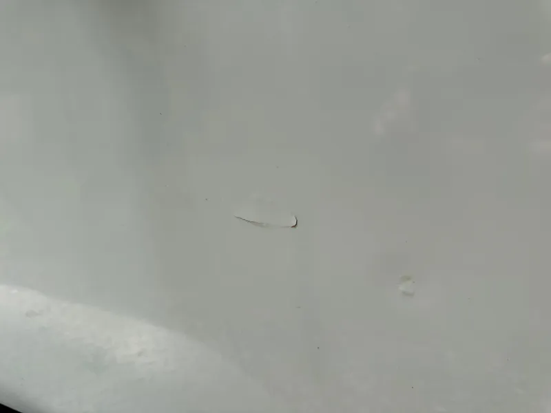 Slide: The Image of Scratch on 1985 Contender 25 Classic boat surface. - 12