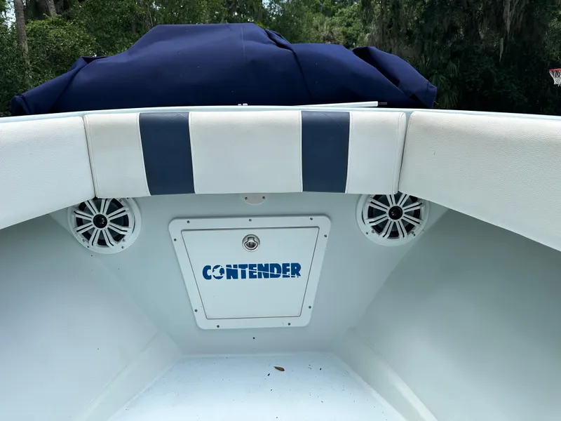 Slide: The Image of 1985 Contender 25 Classic boat interior with speakers and striped upholstery. - 13