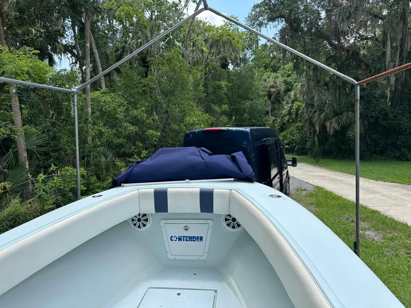 Slide: The Image of 1985 Contender 25 Classic boat on trailer, surrounded by lush greenery. - 17