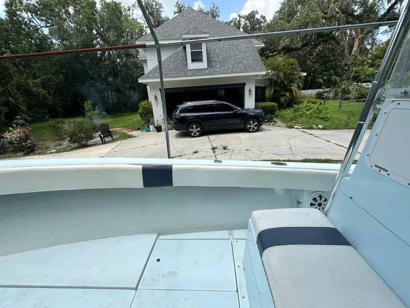 Slide: The Image of 1985 Contender 25 Classic boat parked in driveway near house and SUV. - 19
