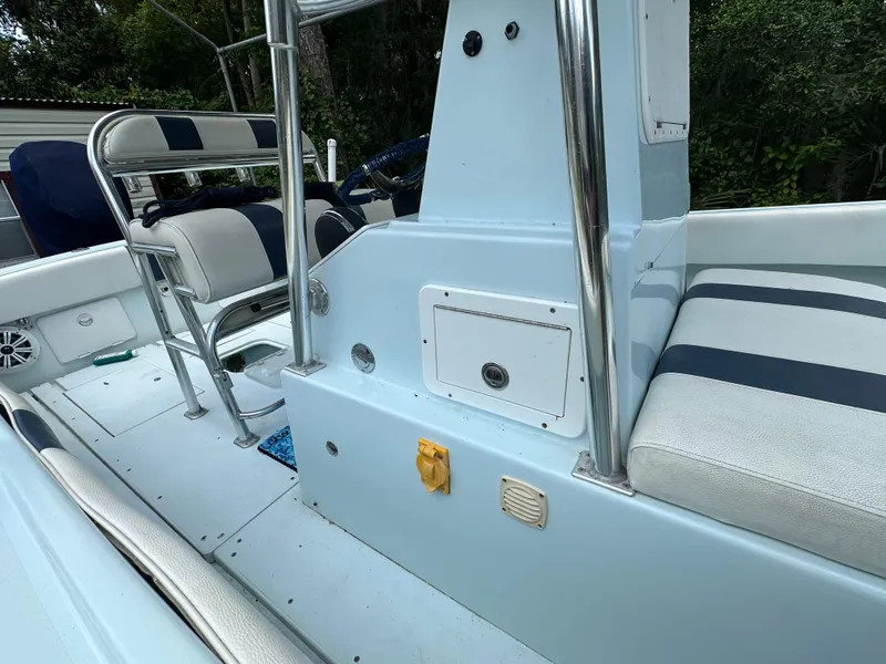 Slide: The Image of 1985 Contender 25 Classic boat interior with seating and console, featuring blue and white upholstery. - 21