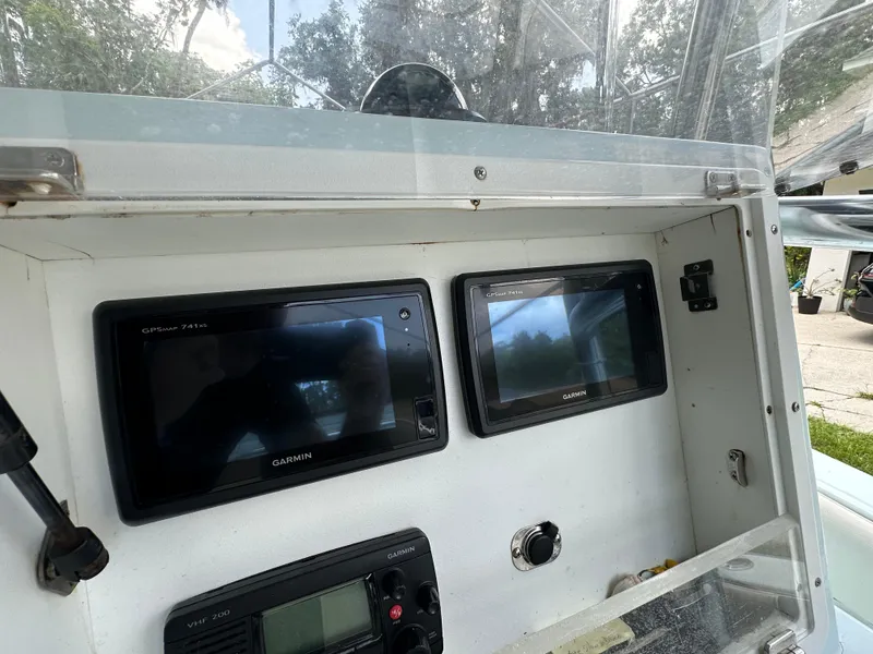 Slide: The Image of Dashboard of a 1985 Contender 25 Classic boat with Garmin navigation displays. - 31