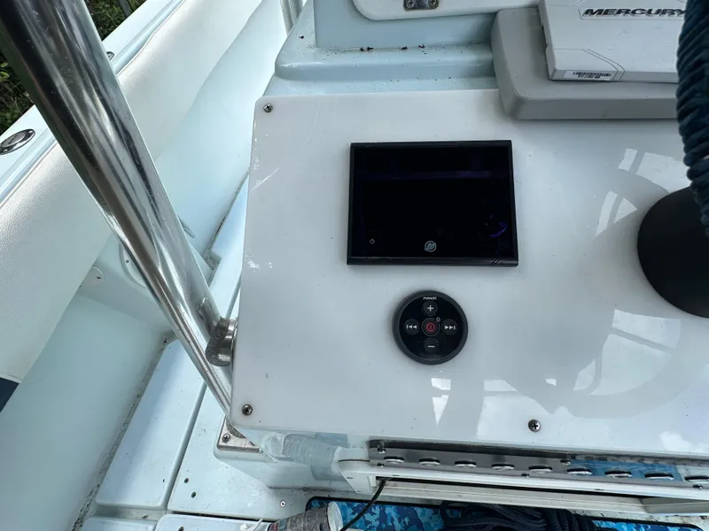 Slide: The Image of Control panel of a 1985 Contender 25 Classic boat with modern navigation equipment. - 34