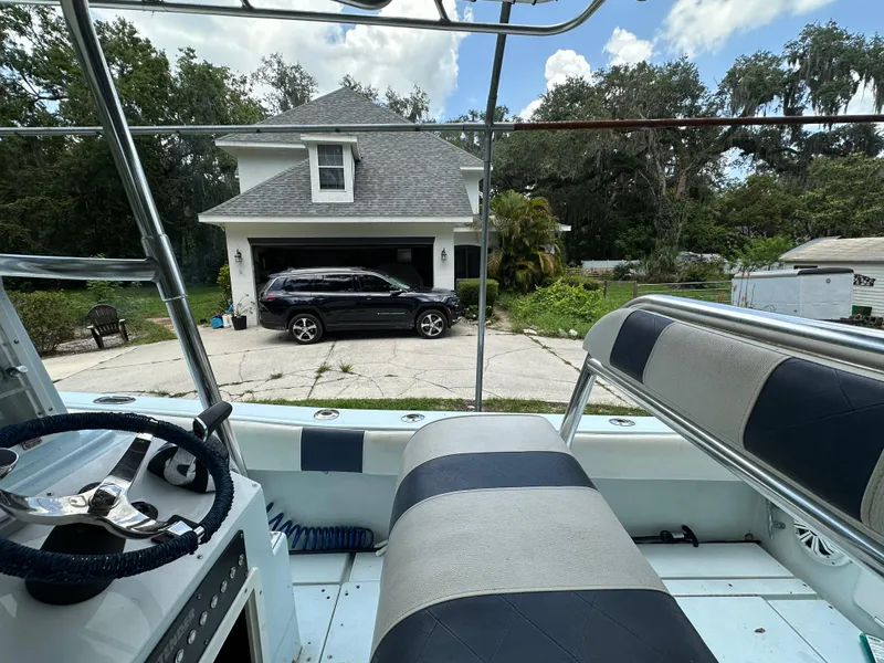 Slide: The Image of 1985 Contender 25 Classic boat interior with view of house and parked SUV. - 36