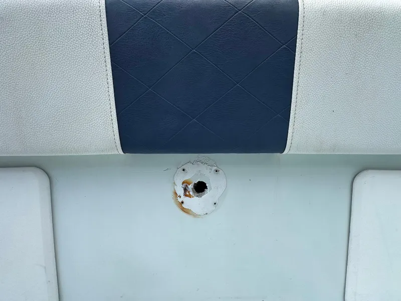 Slide: The Image of 1985 Contender 25 Classic boat seat with a worn, rusted mounting hole. - 41