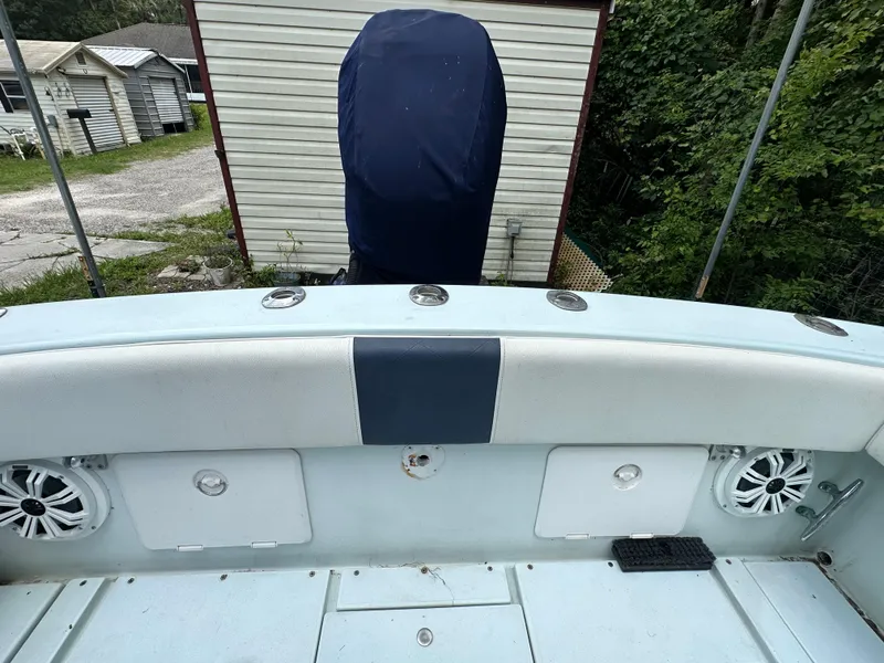 Slide: The Image of 1985 Contender 25 Classic boat interior with covered engine, speakers, and storage compartments. - 42