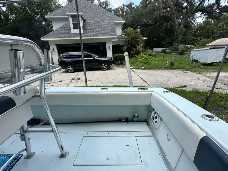 Slide: The Image of 1985 Contender 25 Classic boat parked in residential driveway with house and car in background. - 44