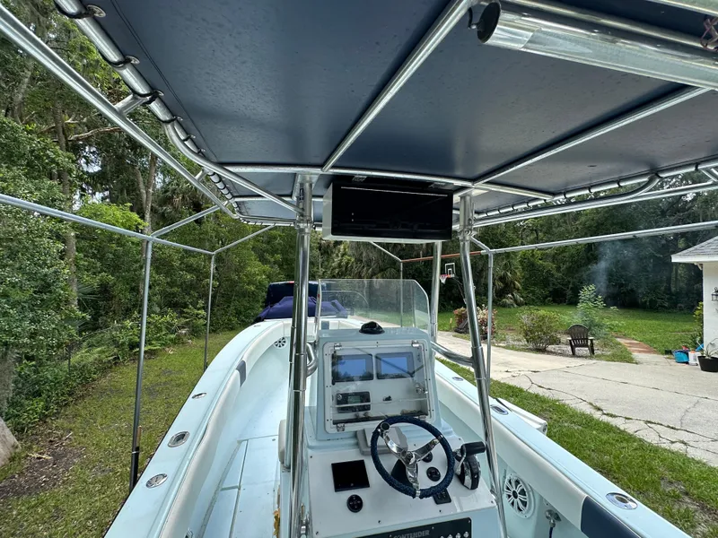 Slide: The Image of 1985 Contender 25 Classic boat with center console and canopy, parked outdoors. - 46