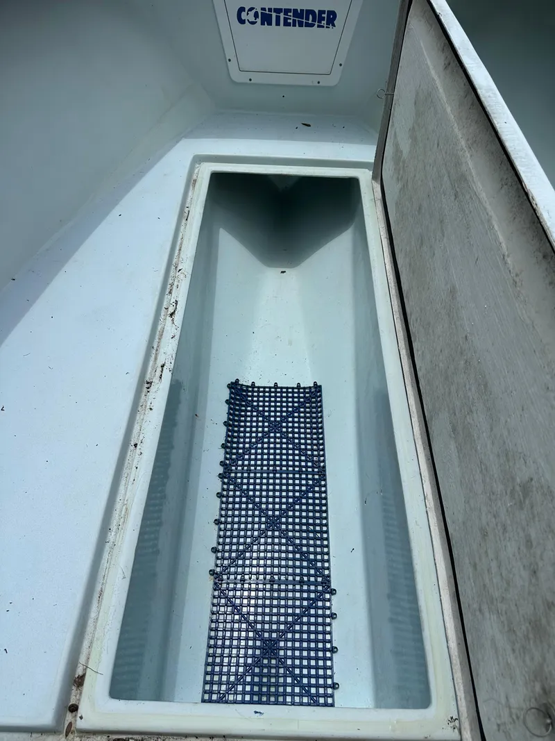Slide: The Image of Open storage compartment of 1985 Contender 25 Classic boat. - 47