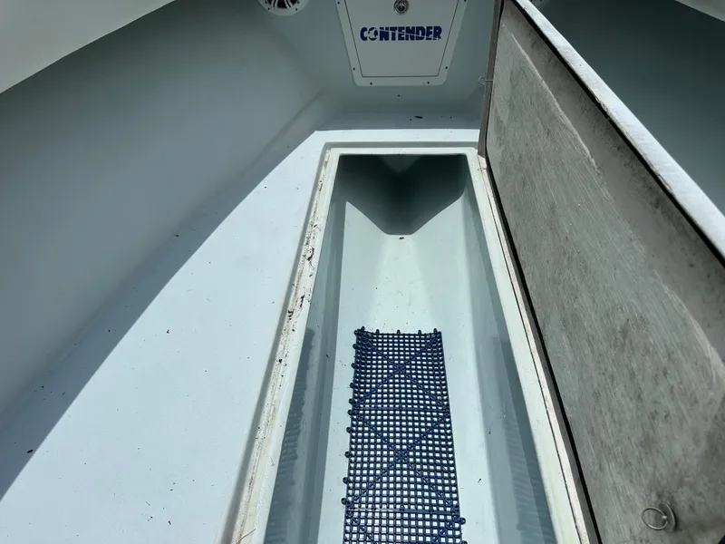 Slide: The Image of 1985 Contender 25 Classic boat interior with storage compartment and non-slip mat. - 48