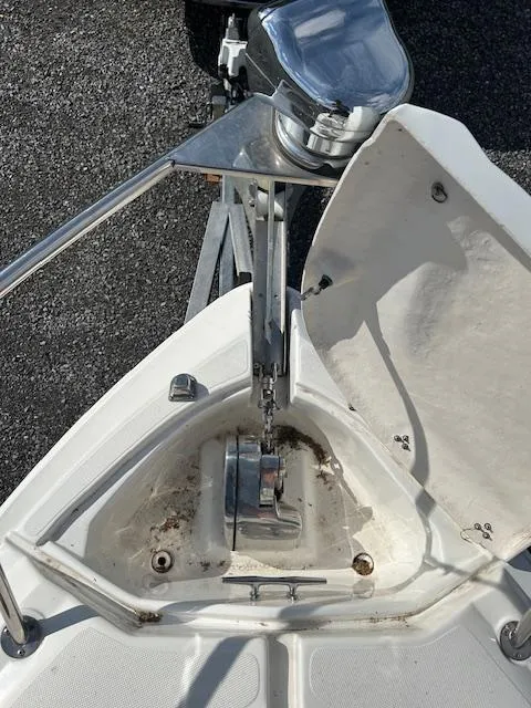 Slide: The Image of 2013 Rinker 290 Express Cruiser anchor compartment with open hatch and chain mechanism. - 29