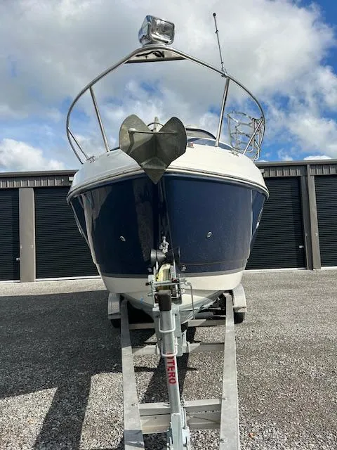 Slide: The Image of 2013 Rinker 290 Express Cruiser on trailer, front view, with blue hull and anchor. - 3