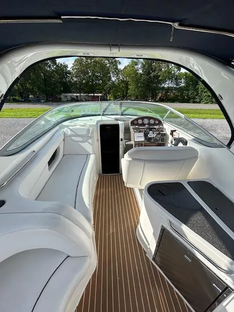 Slide: The Image of 2013 Rinker 290 Express Cruiser interior with white seating and modern dashboard. - 34