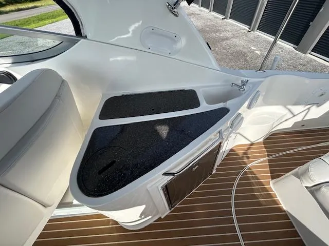 Slide: The Image of 2013 Rinker 290 Express Cruiser interior with sleek countertop and wood flooring. - 36