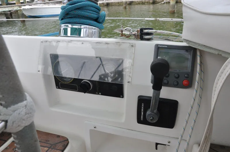 Slide: The Image of Control panel of a 1986 Scanmar 33 sailboat with navigation instruments and throttle lever. - 12